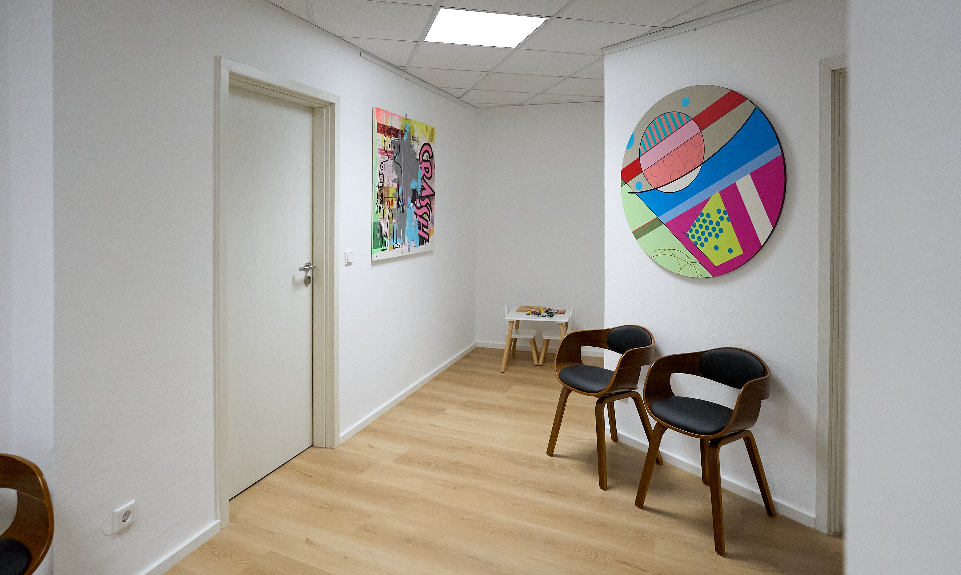 Wartebereich mit Kunstwerken und Kinderspielecke
